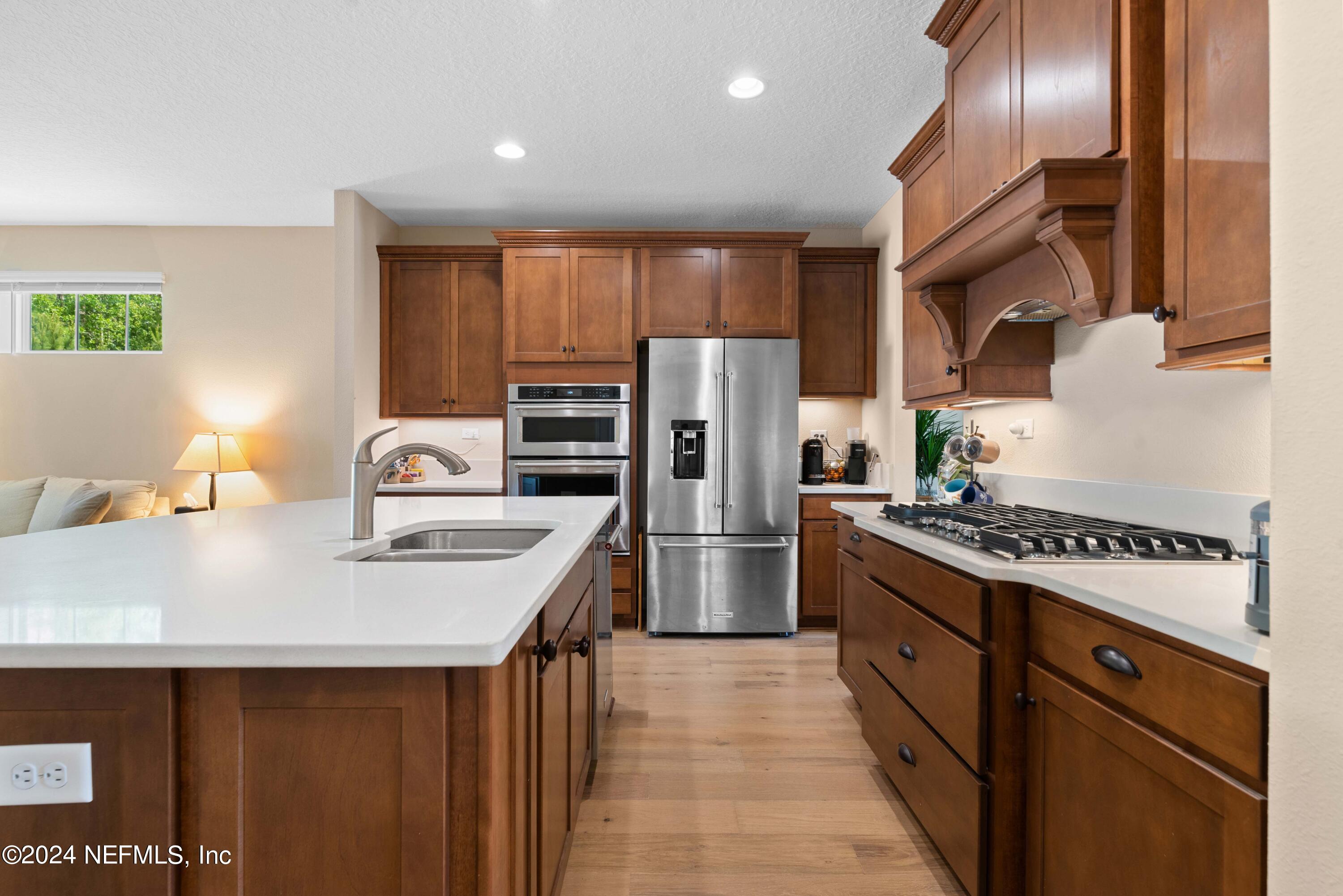 245 Floco Avenue Yulee, FL 32097 - Photo 9 of 38 a kitchen with refrigerator a stove and a sink