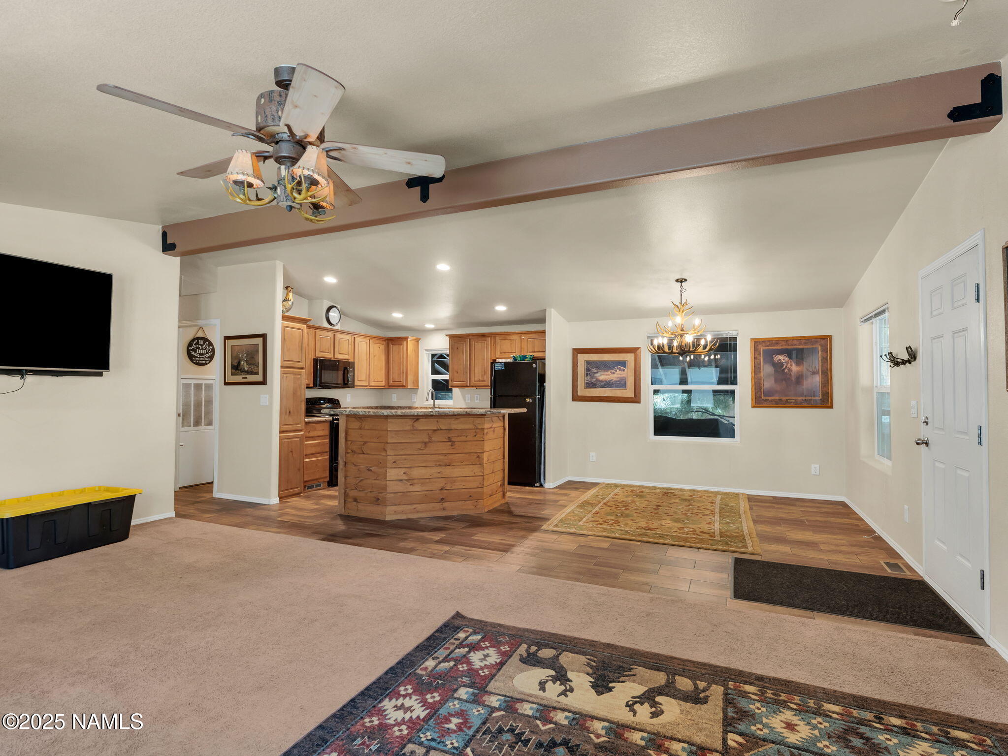 1151 Caribou Road Munds Park, AZ 86017 - Photo 18 of 30 a living room with furniture and a flat screen tv