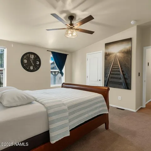 a bedroom with a bed and a ceiling fan