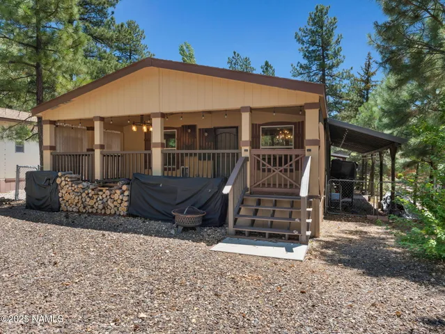 a view of a house with a yard and furniture