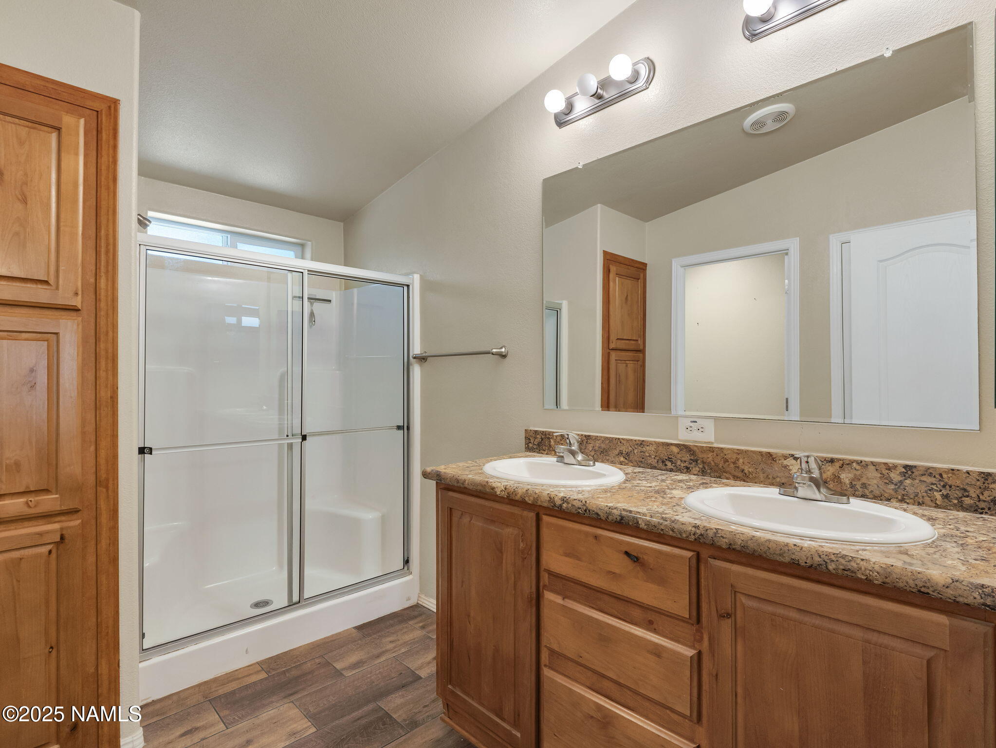 1151 Caribou Road Munds Park, AZ 86017 - Photo 21 of 30 a bathroom with a granite countertop sink two mirror and shower