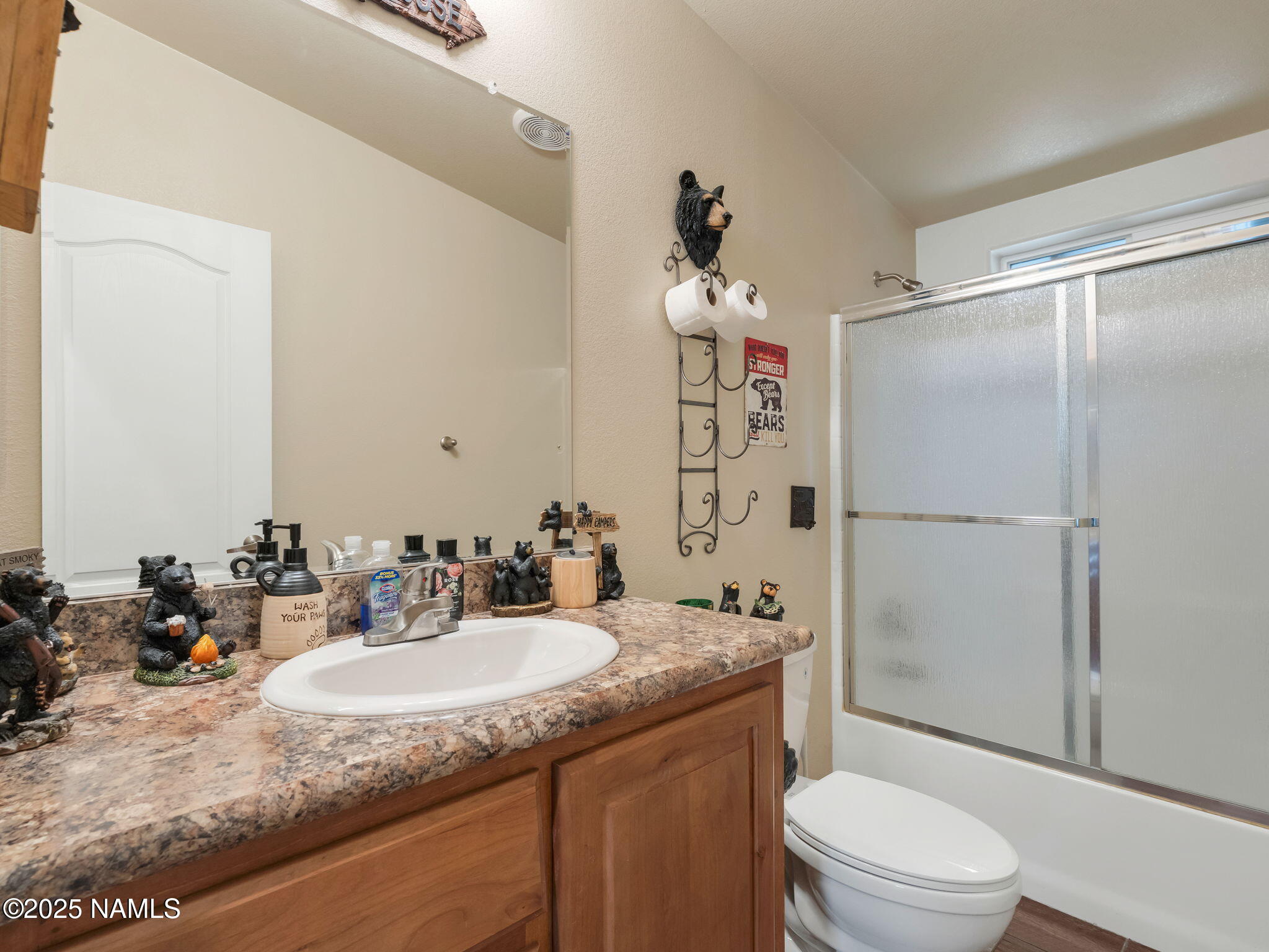 1151 Caribou Road Munds Park, AZ 86017 - Photo 25 of 30 a bathroom with a granite countertop sink toilet and shower