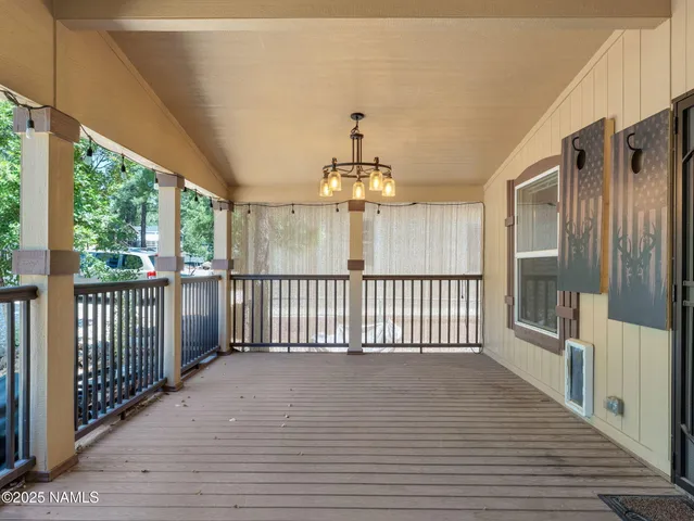 a view of a porch with wooden floor and outdoor space