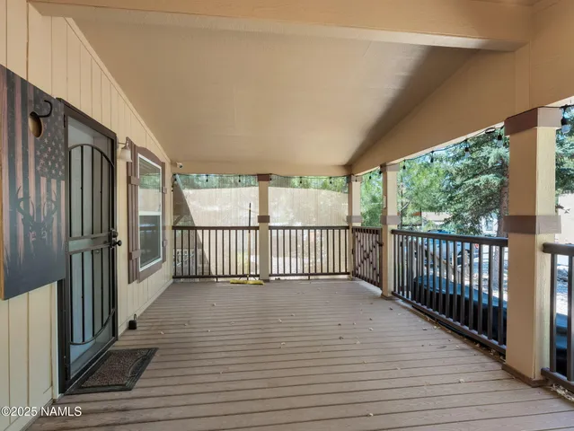 a view of a balcony with wooden floor