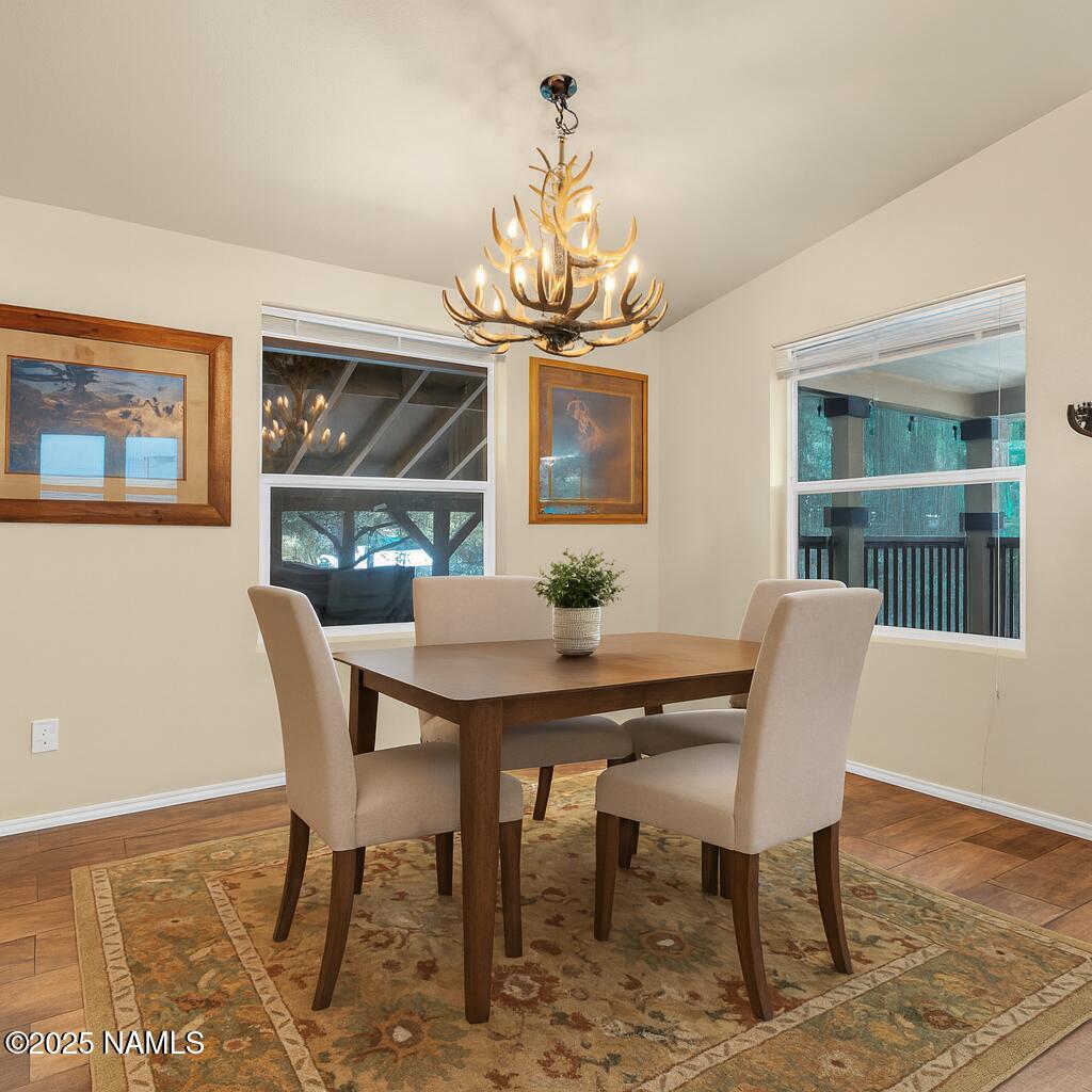 1151 Caribou Road Munds Park, AZ 86017 - Photo 9 of 30 a view of a dining room with furniture window and wooden floor
