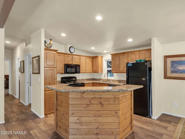 a kitchen with stainless steel appliances granite countertop a refrigerator and a stove