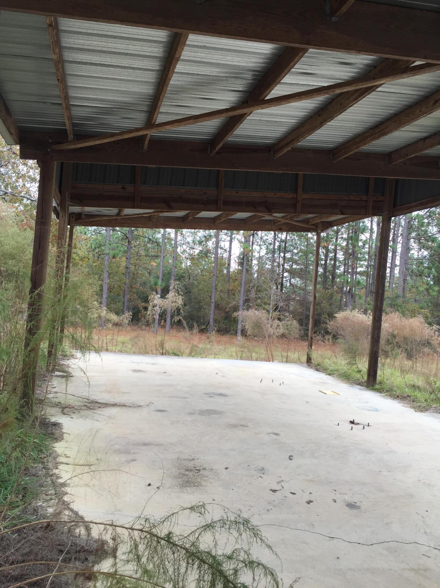 810 Sexton Road DeFuniak Springs, FL 32433 - Photo 14 of 21 a view of empty room with wooden floor and a porch