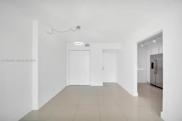 a kitchen with stainless steel appliances a refrigerator sink and microwave