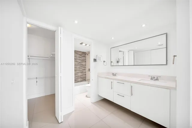a bathroom with a sink vanity and a mirror