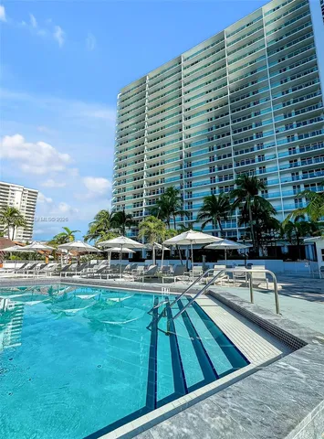 a swimming pool with outdoor seating and yard