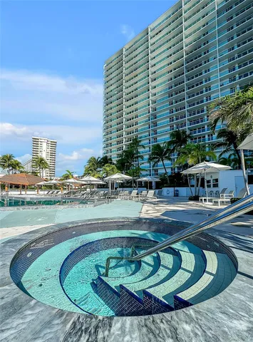 a view of swimming pool with outdoor seating