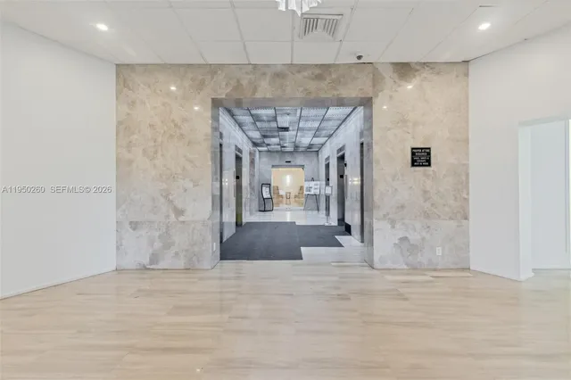a living room with furniture and large windows