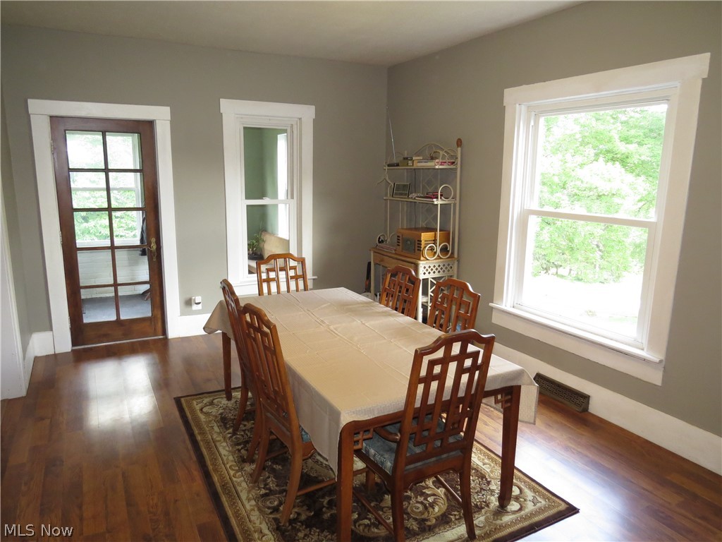 2205 Irish Road Magnolia, OH 44643 - Photo 9 of 31 Dining room with a healthy amount of sunlight and dark hardwood / wood-style floors