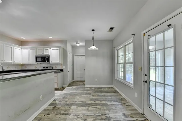 a kitchen with granite countertop a sink stove and refrigerator