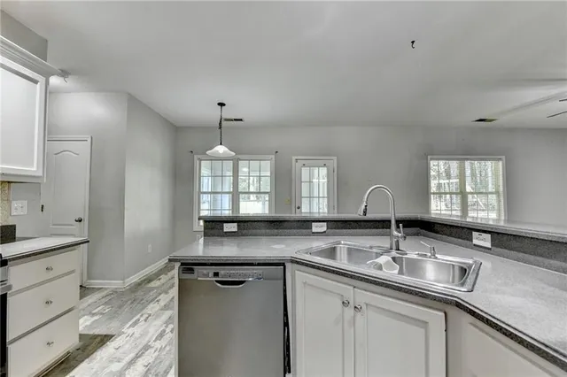 a view of an empty room with a fireplace and a window