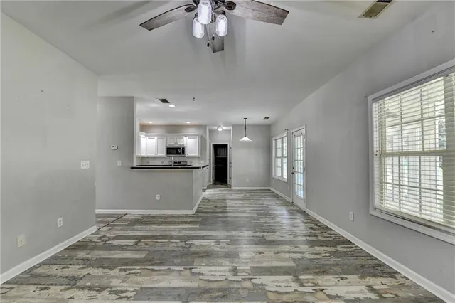 a kitchen with granite countertop white cabinets and a sink