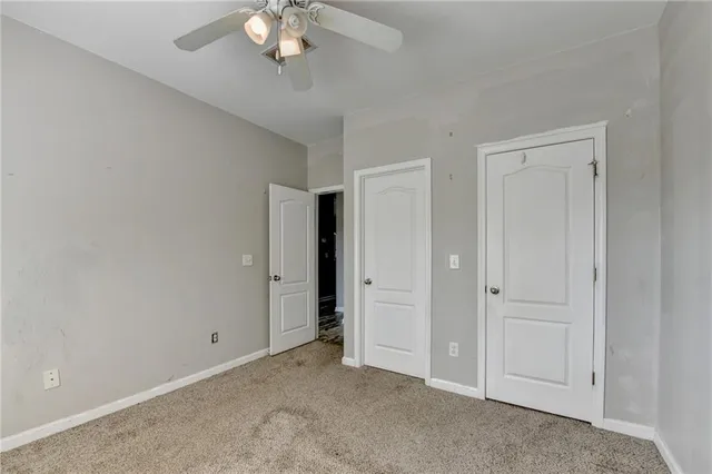 a spacious bathroom with a granite countertop sink a mirror and shower