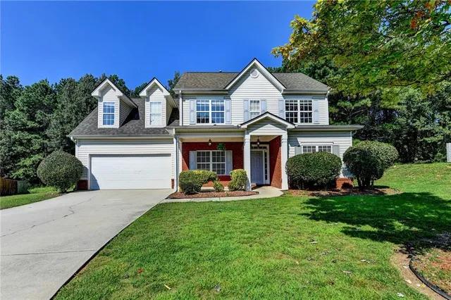 a front view of a house with a yard