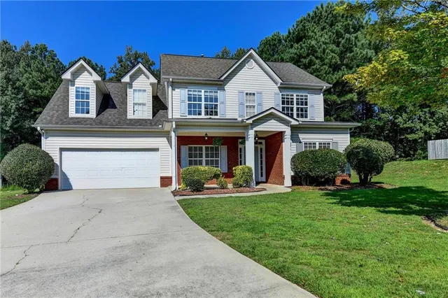 a front view of a house with a yard and porch