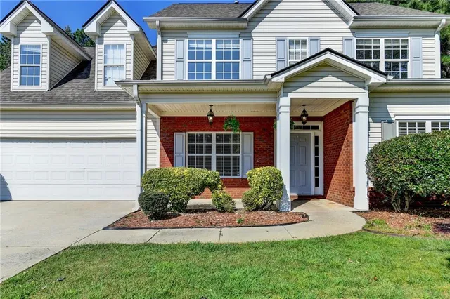a front view of a house with a yard and garage
