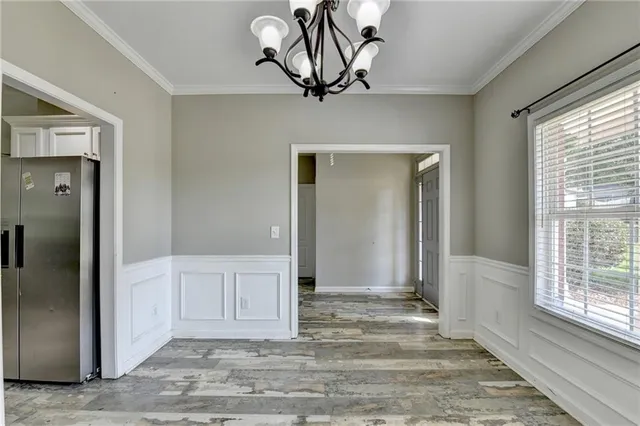 a large kitchen with stainless steel appliances granite countertop a stove and a refrigerator