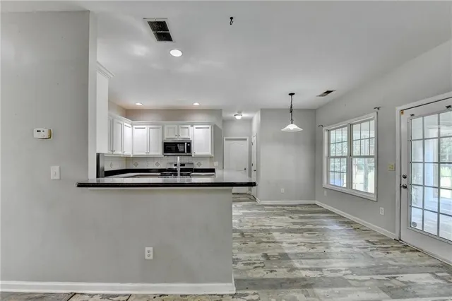 a kitchen with stainless steel appliances granite countertop a sink a refrigerator and a stove