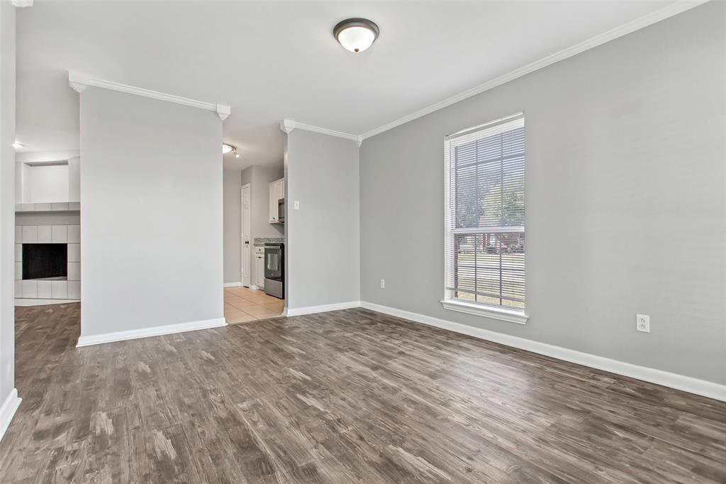 712 Billups Street Van Alstyne, TX 75495 - Photo 12 of 38 a view of an empty room with a window and wooden floor