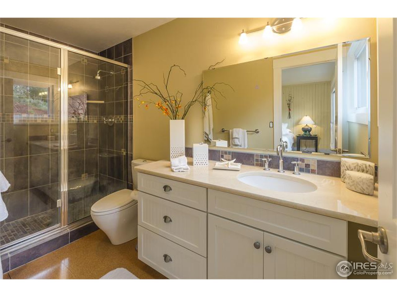 6909 Olde Stage Road Boulder, CO 80302 - Photo 10 of 23 a bathroom with a double vanity sink mirror and shower