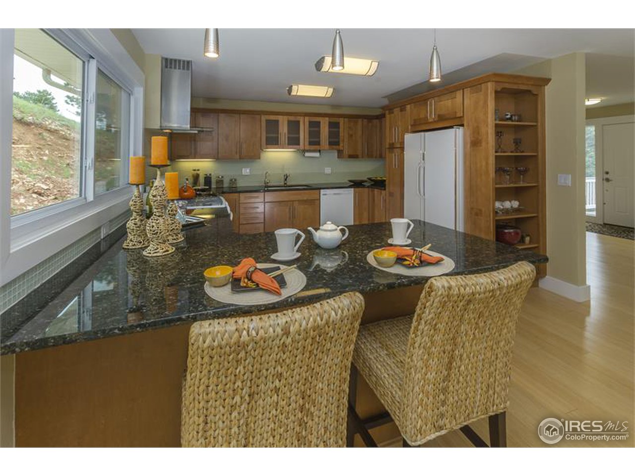 6909 Olde Stage Road Boulder, CO 80302 - Photo 3 of 23 a kitchen with stainless steel appliances granite countertop a refrigerator a stove and a sink with wooden floor
