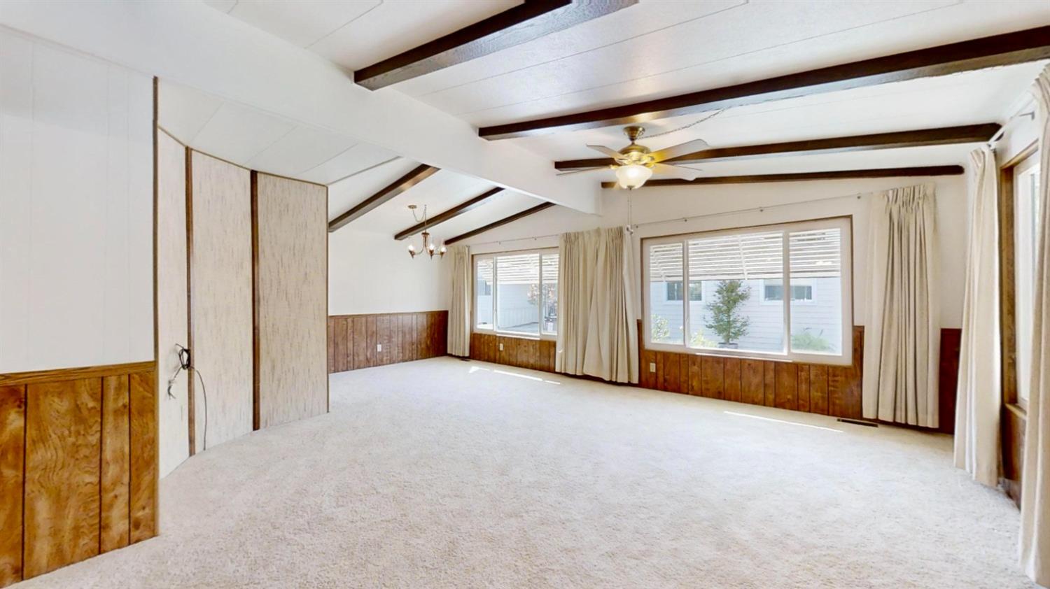 156 Rimma Way Roseville, CA 95661 - Photo 2 of 24 en empty room with windows and ceiling fan