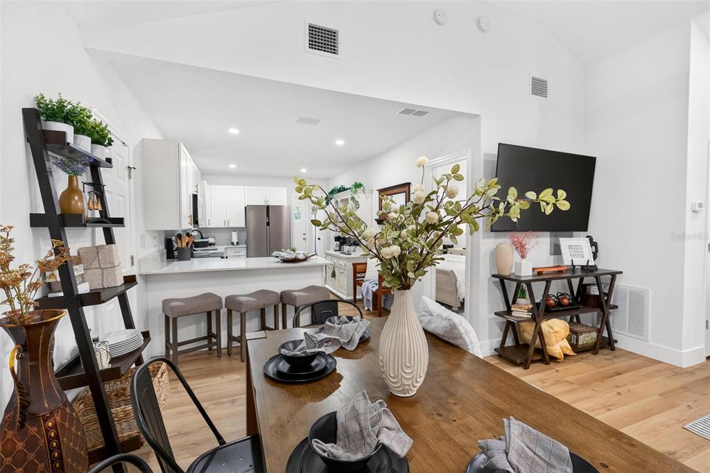 1503 Granite State Court Mount Dora, FL 32757 - Photo 18 of 77 a view of a dining room with furniture and wooden floor