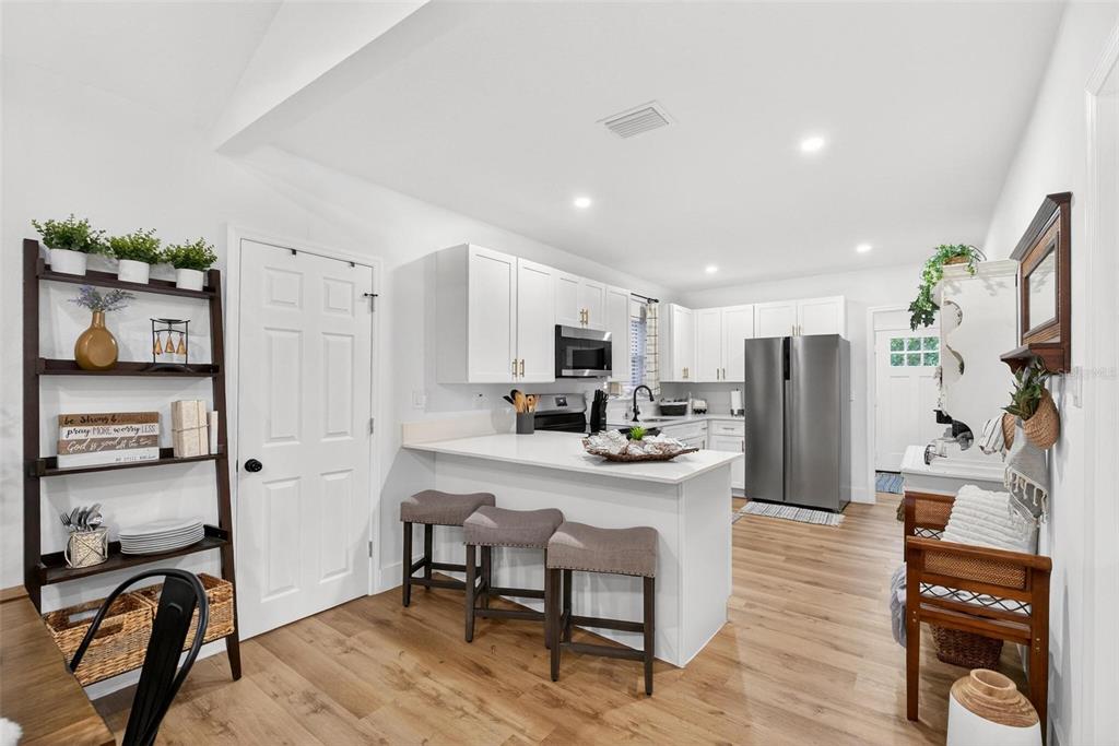 1503 Granite State Court Mount Dora, FL 32757 - Photo 24 of 77 a kitchen with stainless steel appliances a refrigerator and a stove top oven