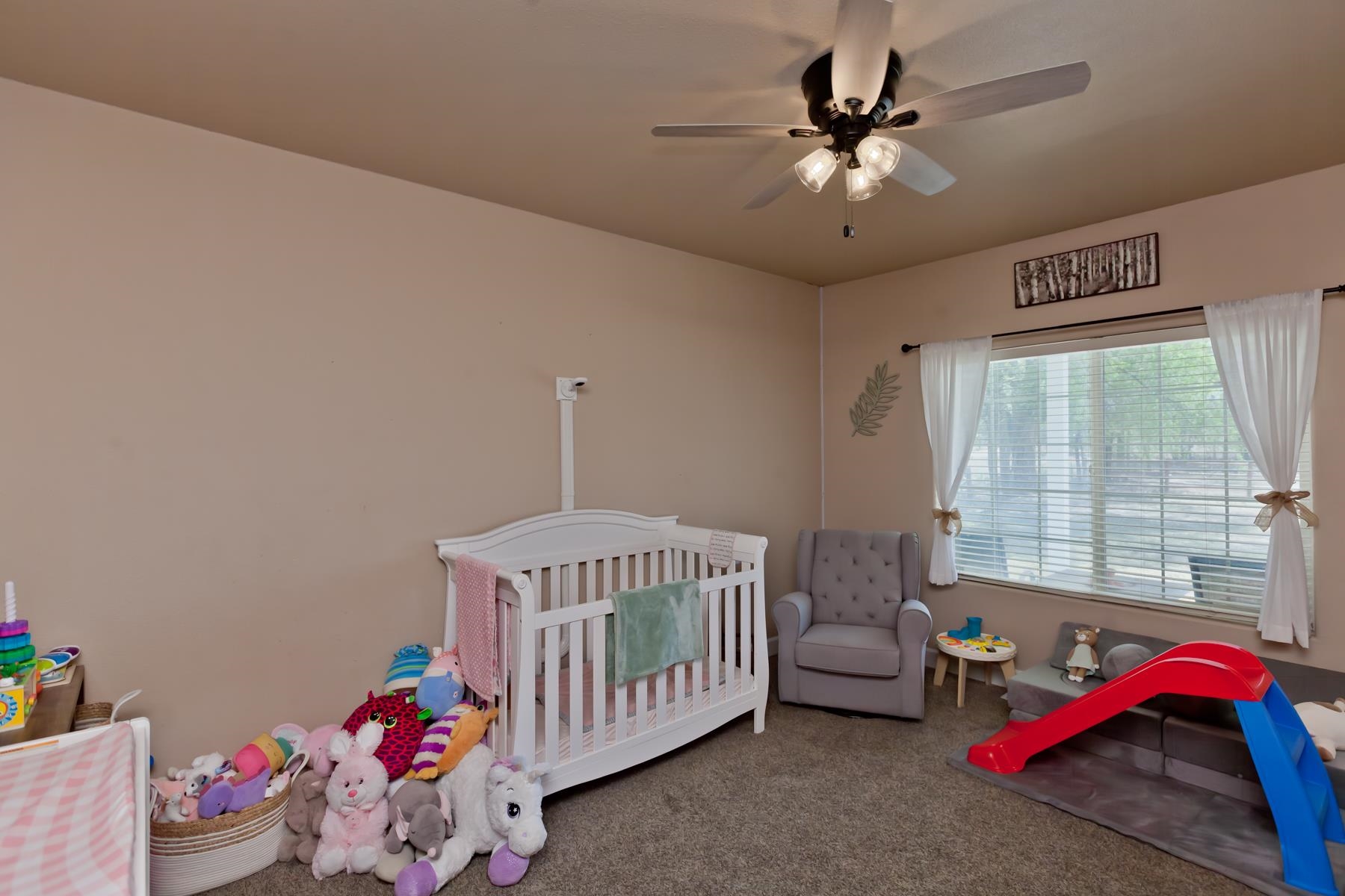 2314 Broadway Grand Junction, CO 81507 - Photo 20 of 39 a bedroom with a bed and a chandelier