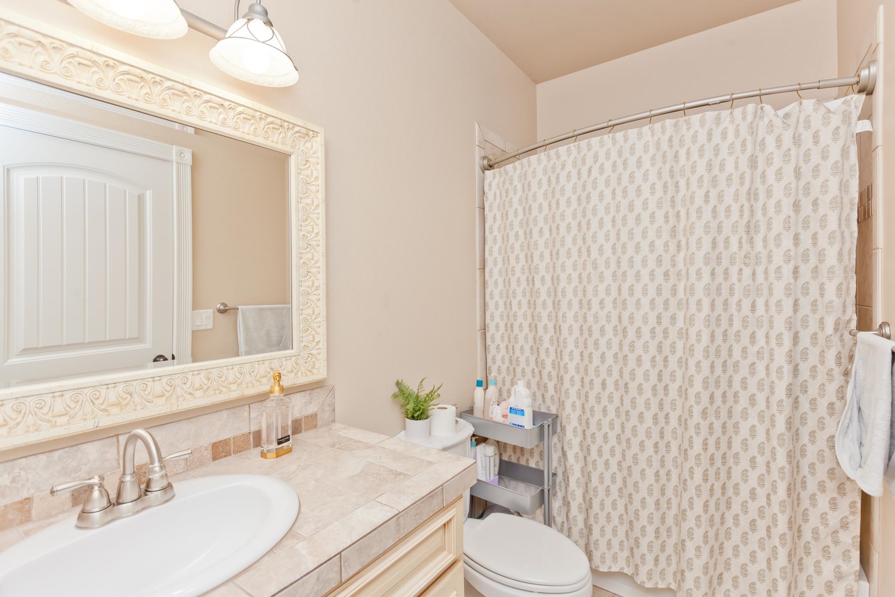 2314 Broadway Grand Junction, CO 81507 - Photo 23 of 39 a bathroom with a sink a toilet and shower curtain
