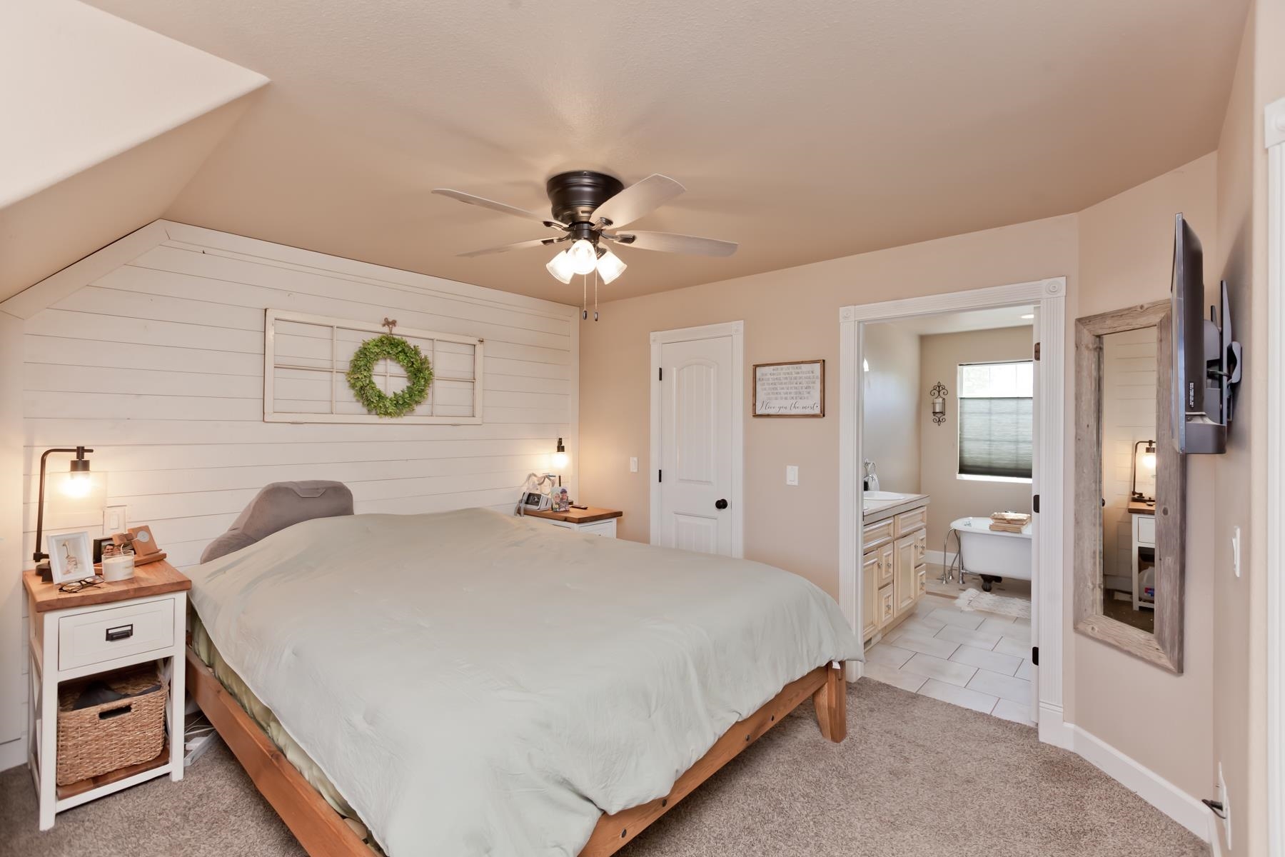 2314 Broadway Grand Junction, CO 81507 - Photo 25 of 39 a spacious bedroom with a bed and a chandelier