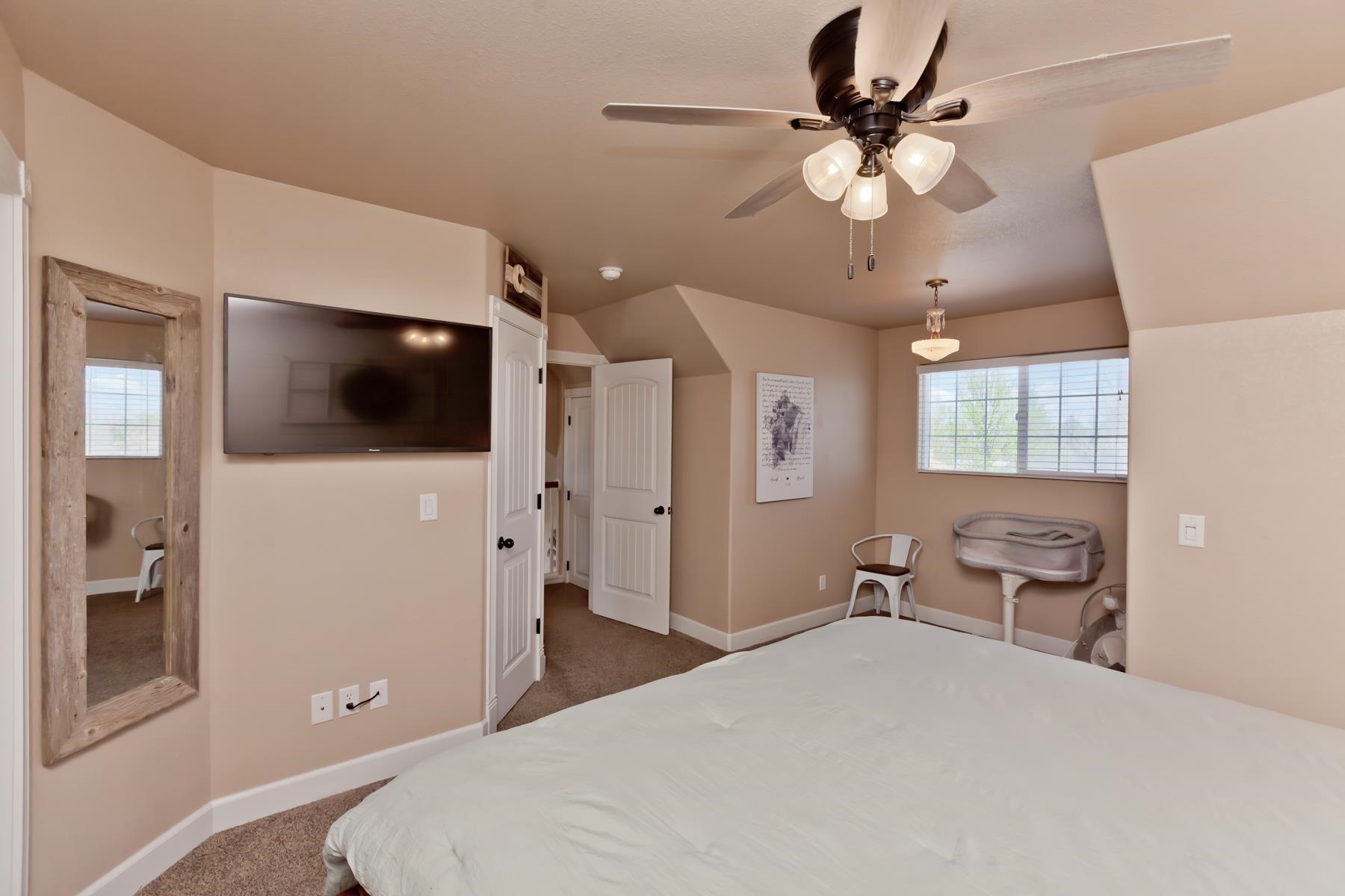 2314 Broadway Grand Junction, CO 81507 - Photo 26 of 39 a bedroom with a bed and a flat screen tv