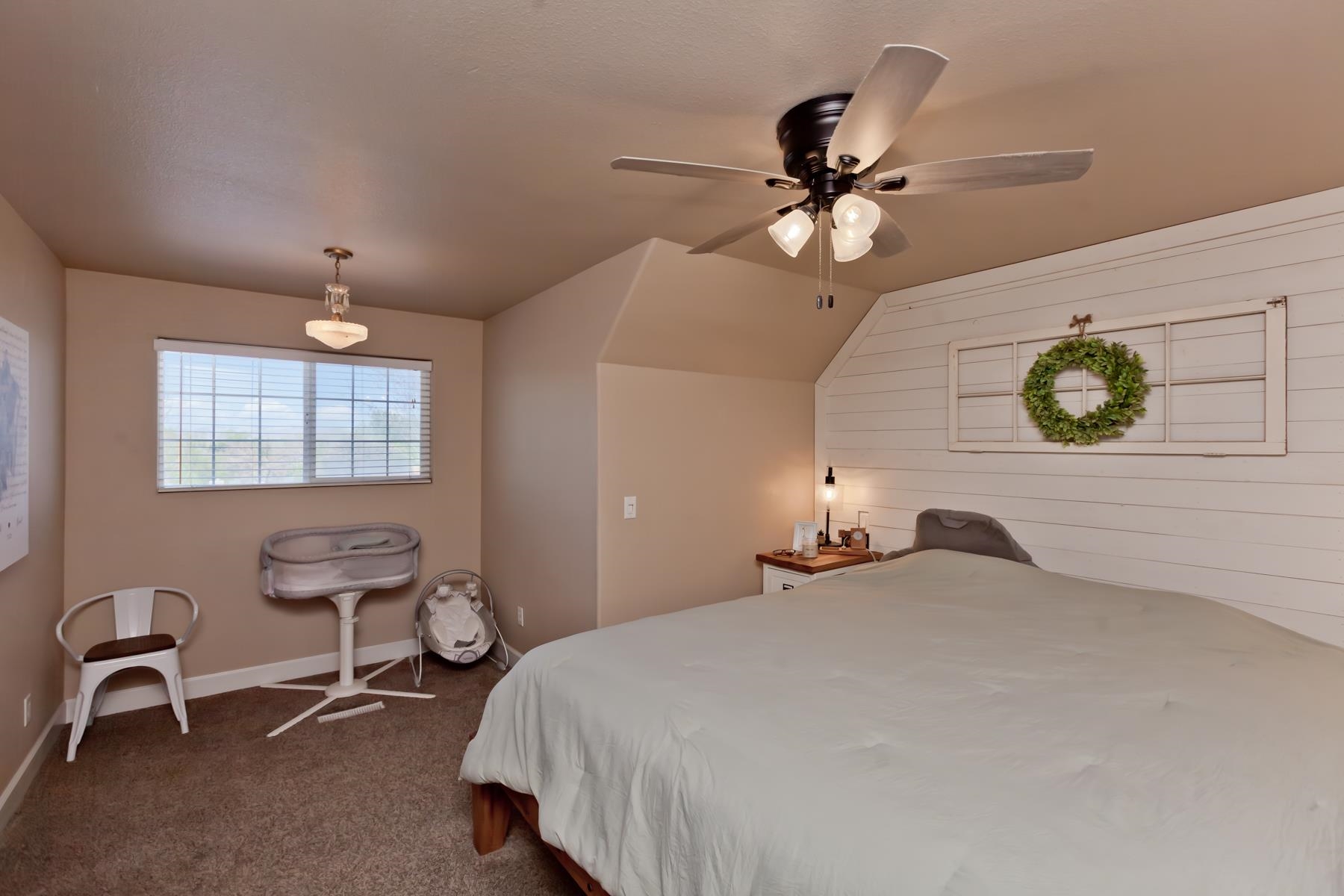 2314 Broadway Grand Junction, CO 81507 - Photo 27 of 39 a bedroom with a bed and a chandelier
