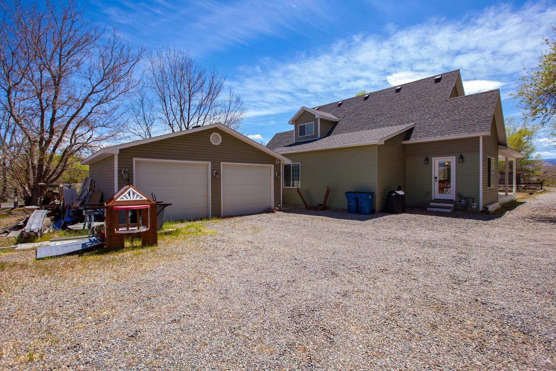 2314 Broadway Grand Junction, CO 81507 - Photo 32 of 39 a front view of a house with a yard and garage