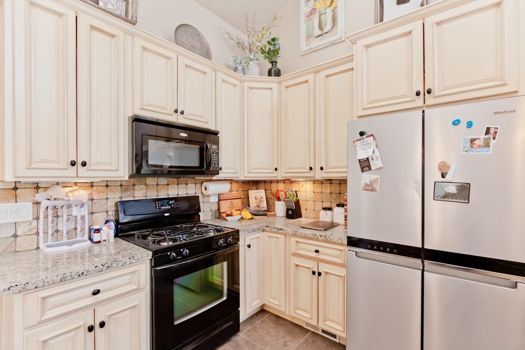 2314 Broadway Grand Junction, CO 81507 - Photo 4 of 39 a white kitchen with stainless steel appliances granite countertop a refrigerator sink stove and white cabinets