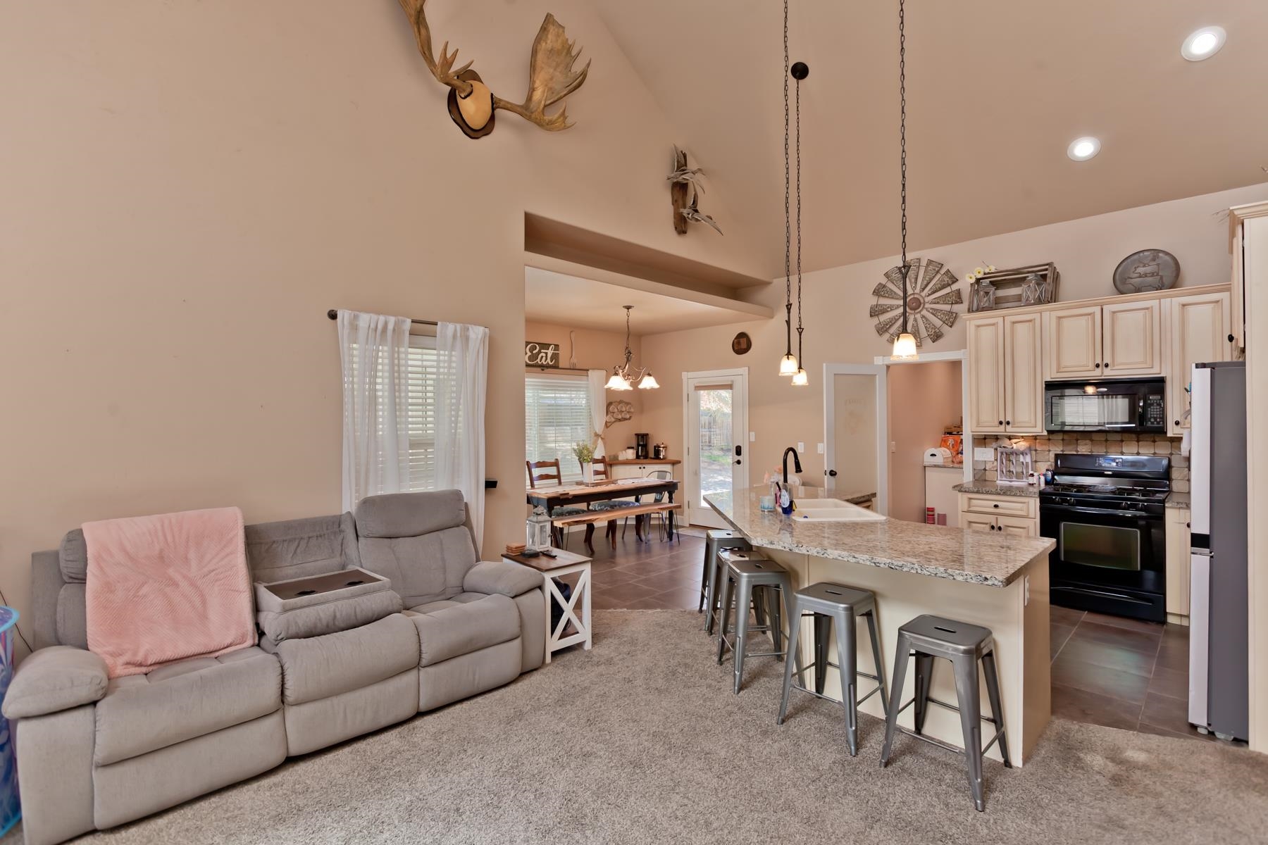 2314 Broadway Grand Junction, CO 81507 - Photo 7 of 39 a living room with furniture kitchen view and a chandelier