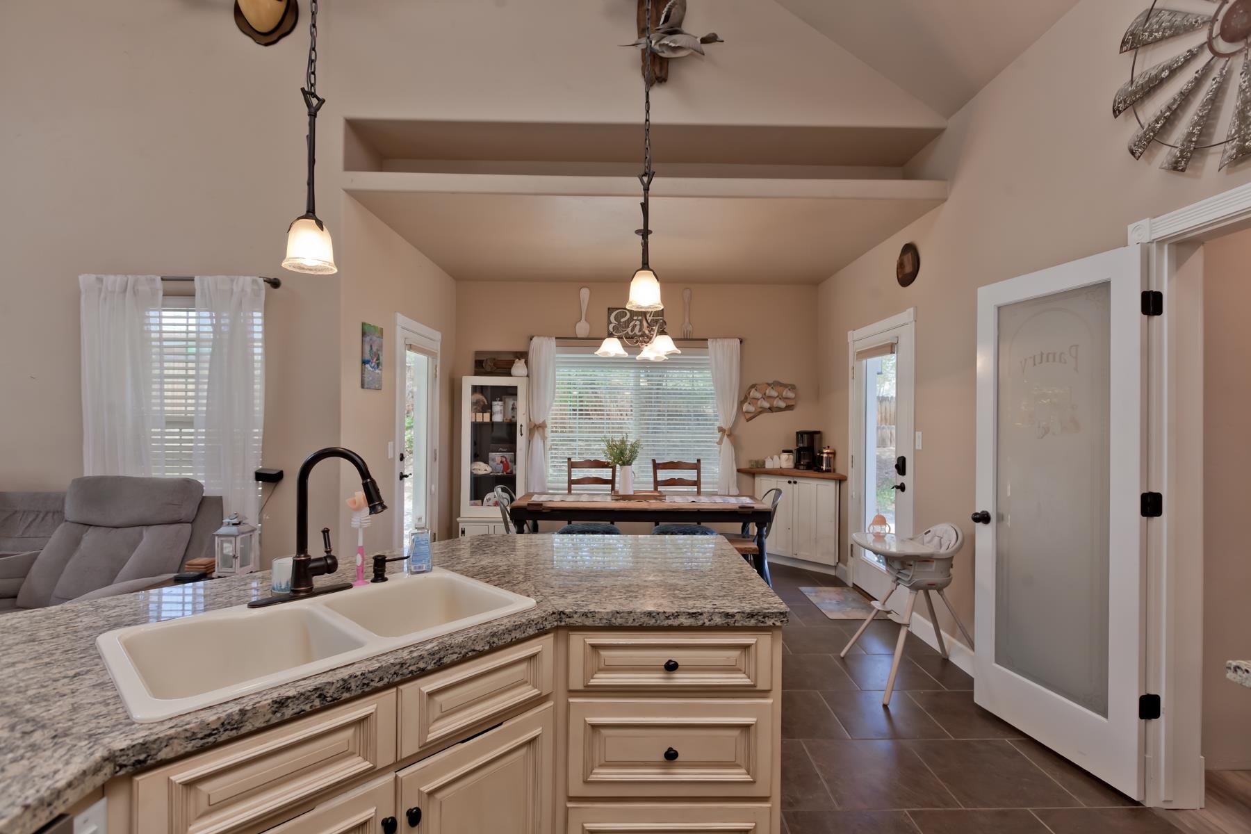 2314 Broadway Grand Junction, CO 81507 - Photo 8 of 39 a kitchen with a chandelier a sink and cabinets