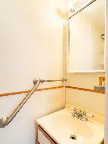 a white toilet sitting next to a shower