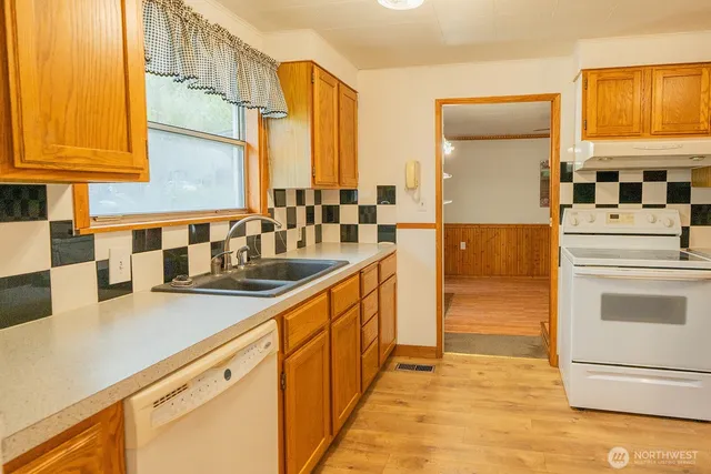 a kitchen with stainless steel appliances a sink and cabinets