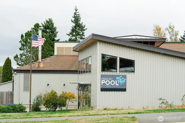 a view of a pathway gate with wooden fence