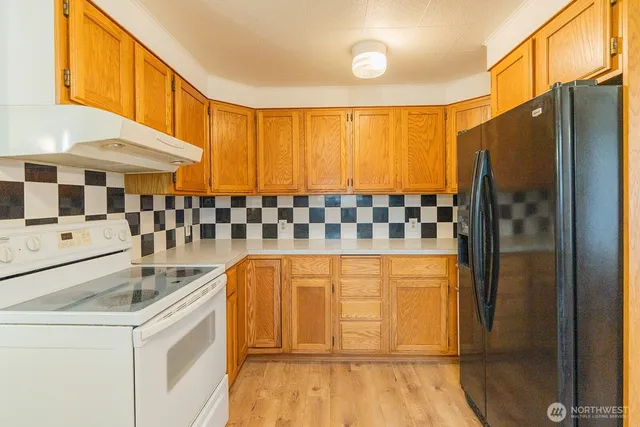 a kitchen with stainless steel appliances granite countertop a sink and cabinets