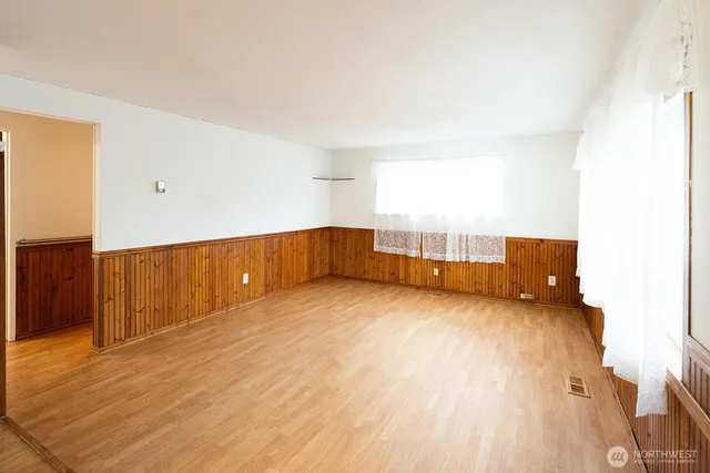 a view of an empty room with wooden floor