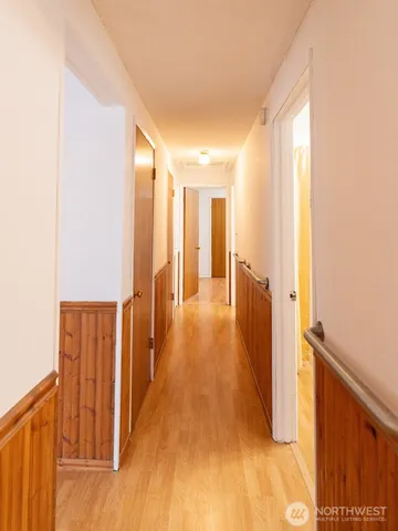 a view of a hallway with wooden floor