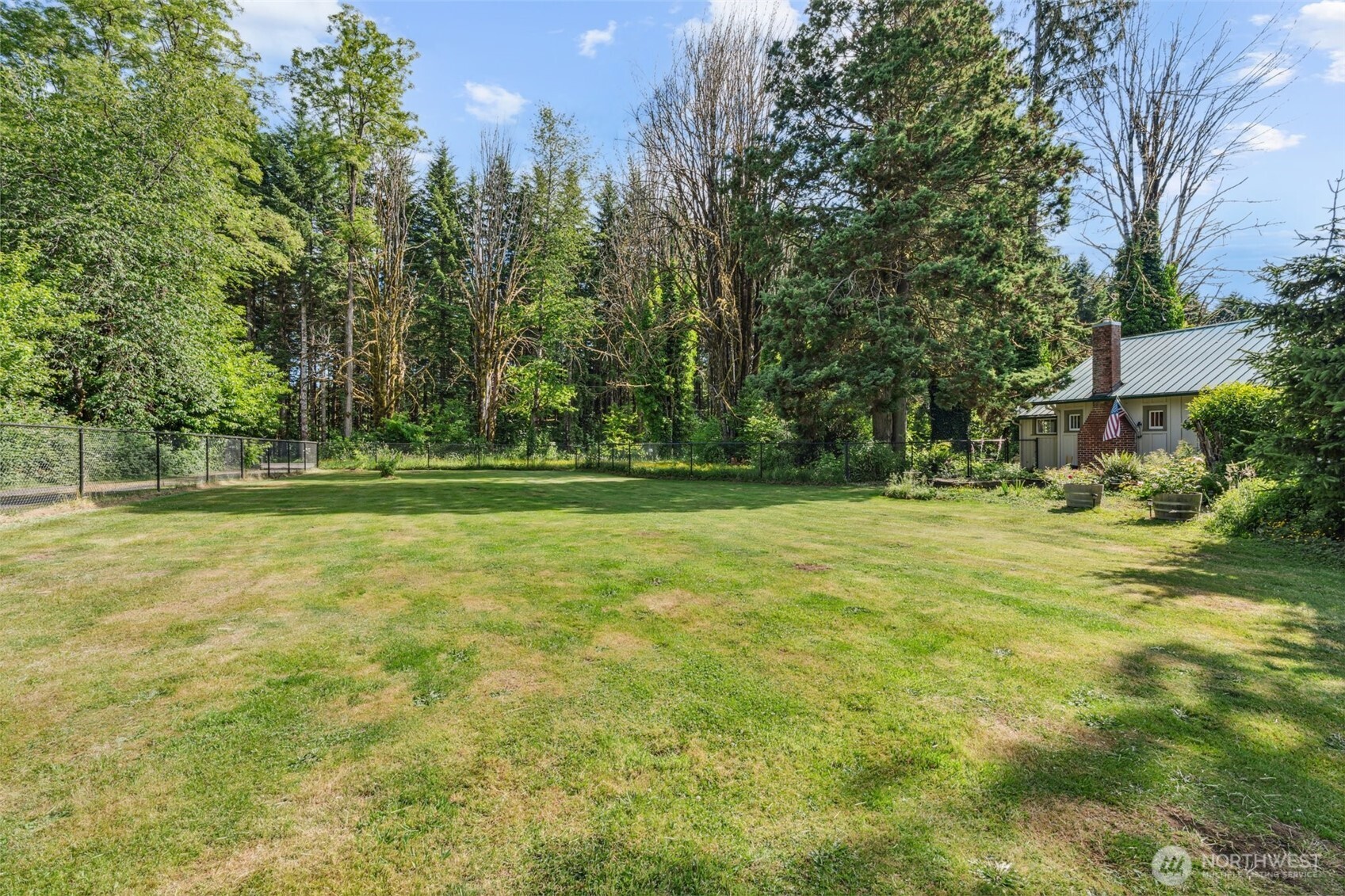 3381 Centralia Alpha Road Onalaska, WA 98570 - Photo 23 of 30 a backyard of a house with lots of green space and fountain