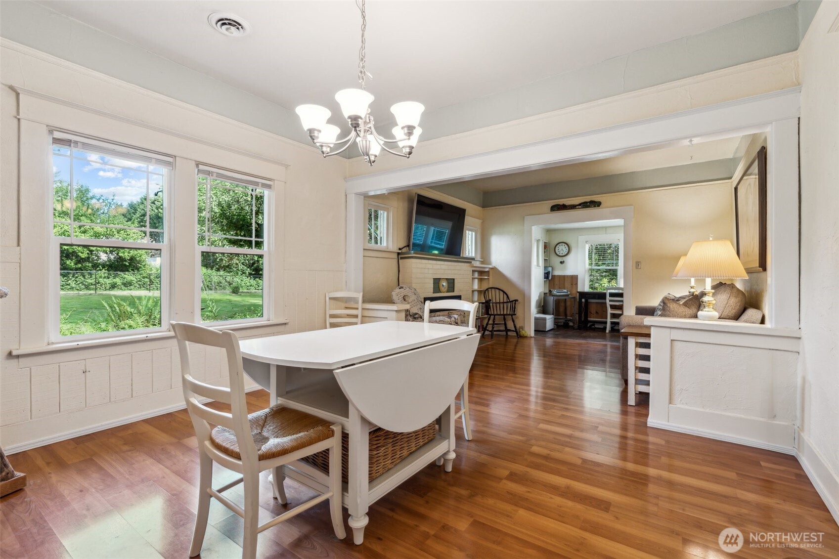 3381 Centralia Alpha Road Onalaska, WA 98570 - Photo 8 of 30 a dining room with wooden floor a chandelier a wooden table and chairs
