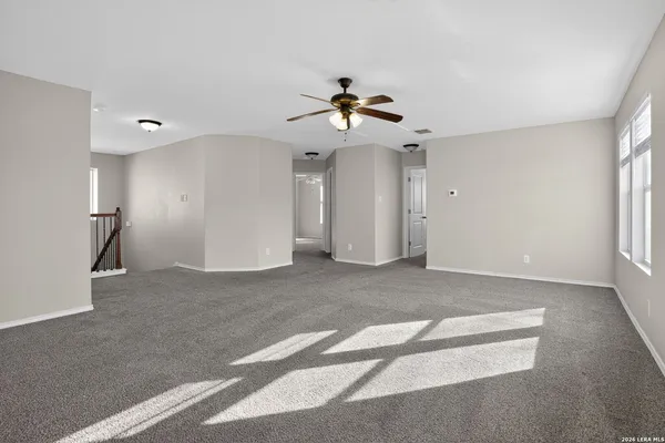 a view of a livingroom with a ceiling fan and window